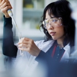 Researcher holding a syringe and vial
