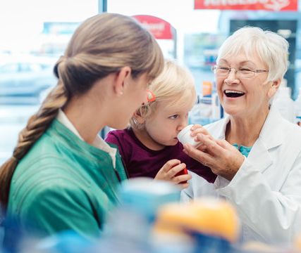Pharmacist helping mother and young child
