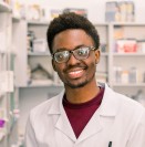 Smiling student pharmacist wearing a lab coat